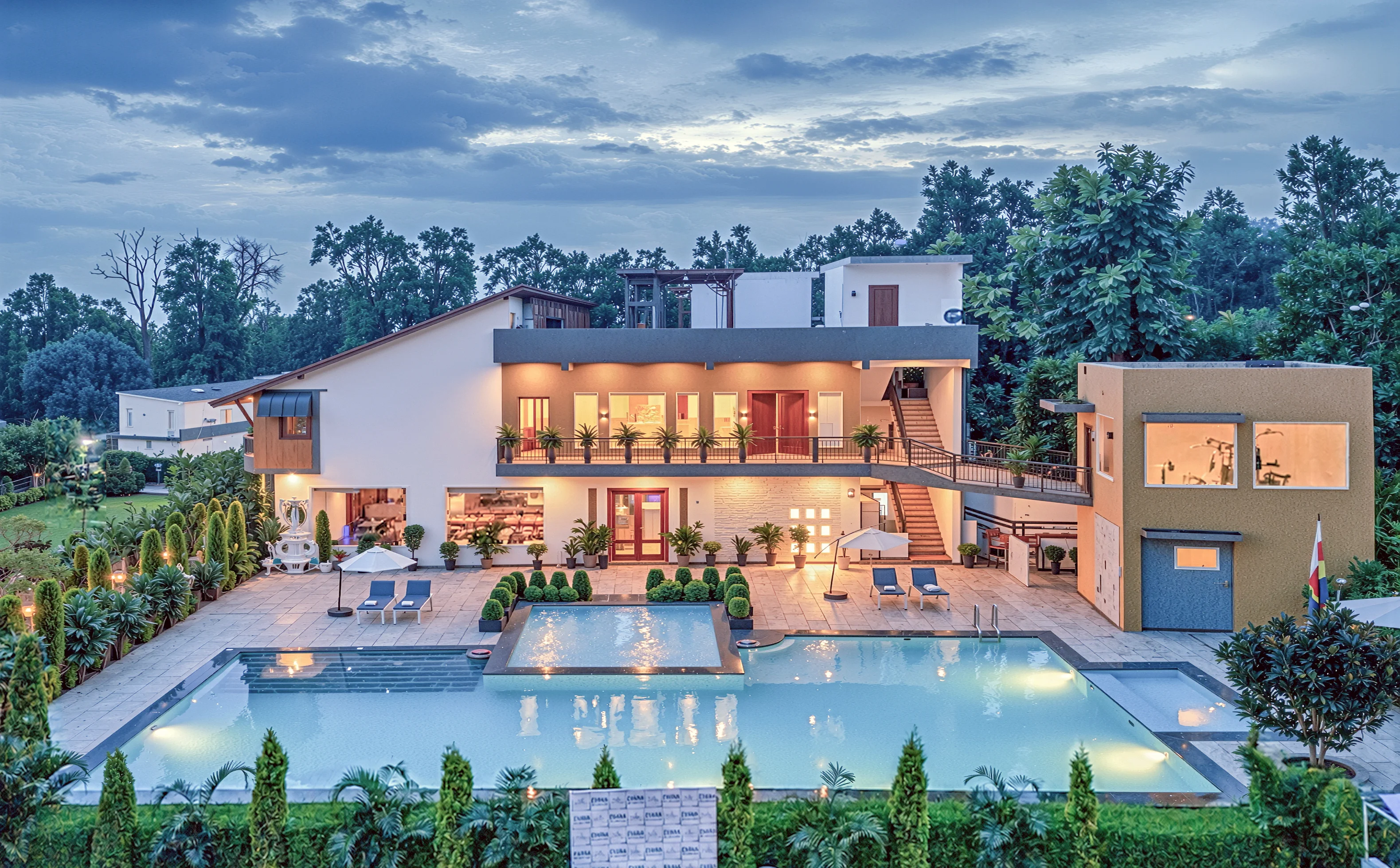 The lawns and cottages of Evara Spa & Resort at dusk
